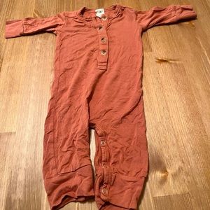 Muted rusty red one piece from Kate Quinn. Size 0-3 months. Good condition